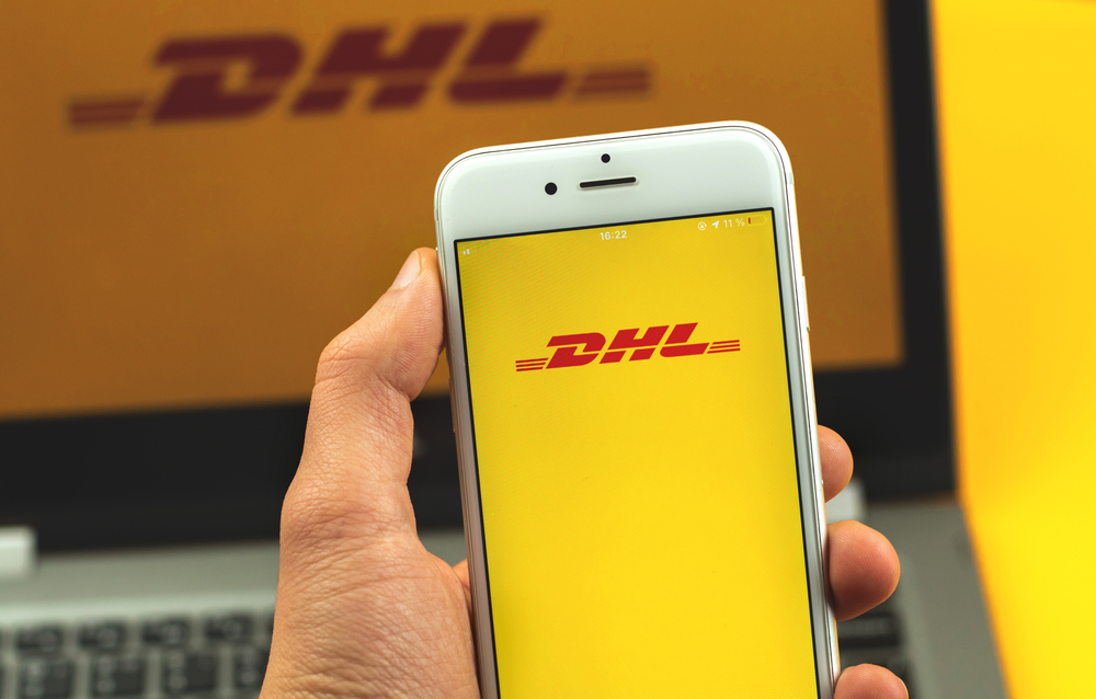 Kharkov, Ukraine – February 22, 2021: DHL app on screen of Apple smartphone, logo of shipping company, background